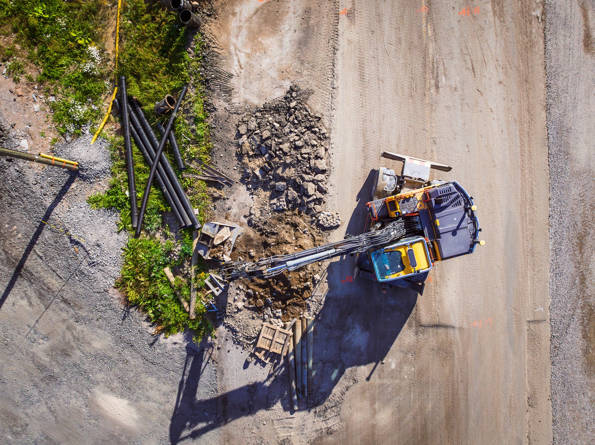 Drone photo of excavator on the construction site.