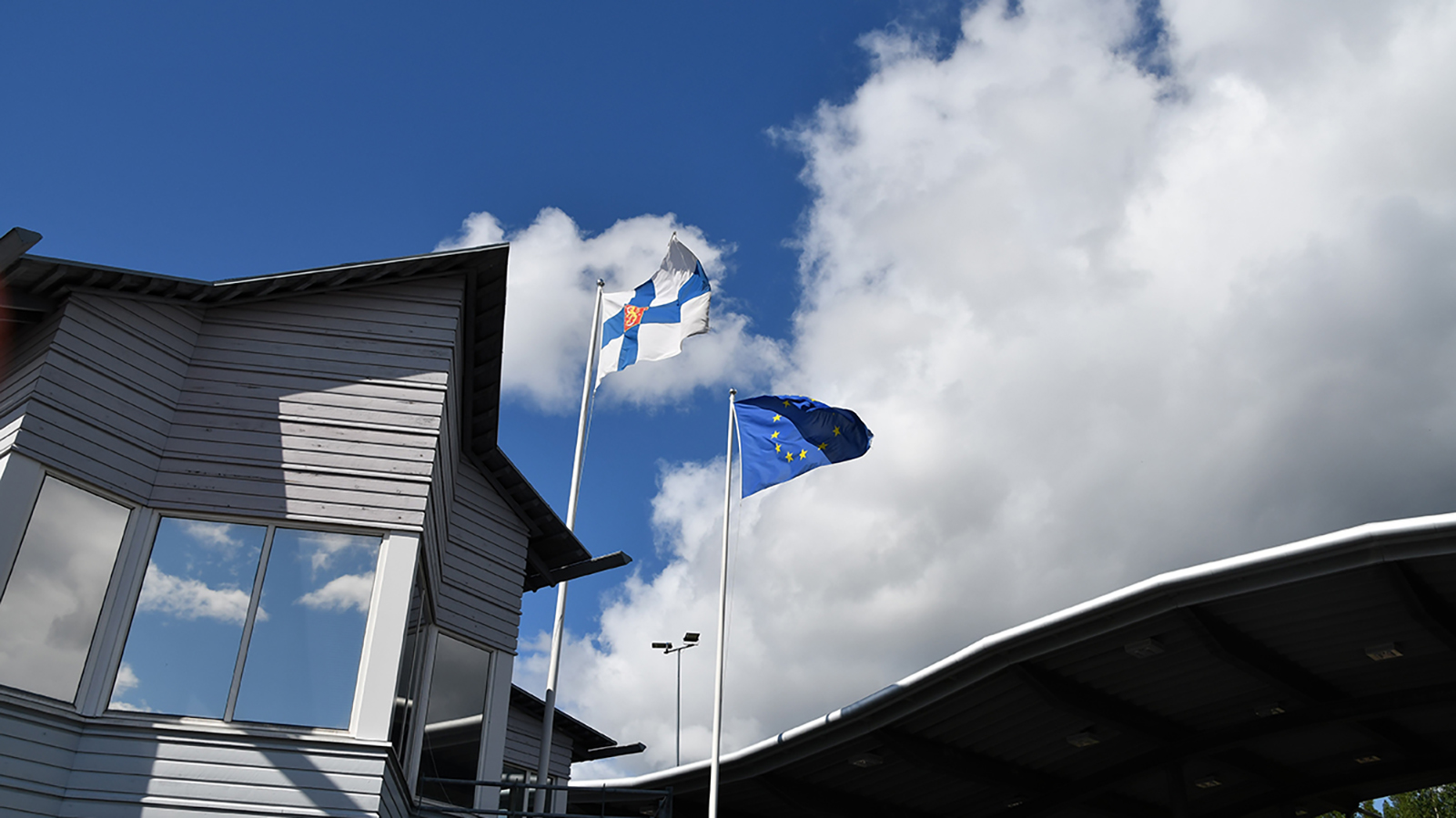 Finland's and EU's flags in the Vartius border crossing point in August 2021.